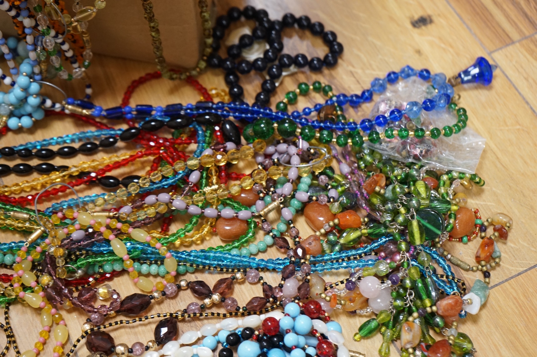 A large collection of glass bead necklaces